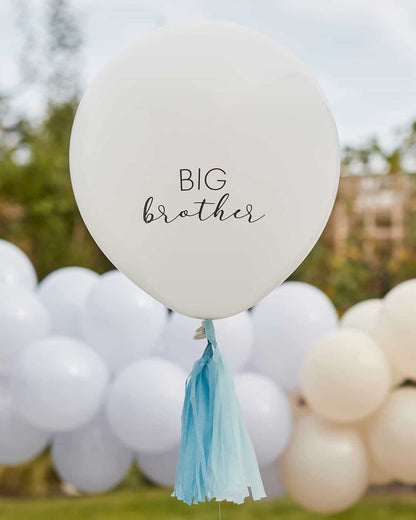 White balloon with "BIG brother" text and blue tassels, set against a backdrop of soft pastel balloons.