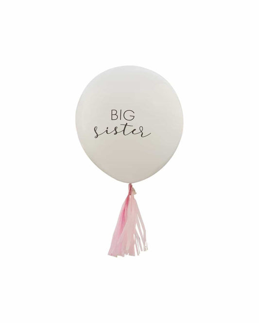 White balloon with "BIG sister" text, adorned with pink tassels at the bottom.