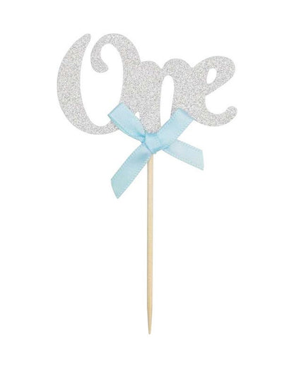 Glittery silver "One" topper with a light blue bow, mounted on a wooden stick for celebrations.