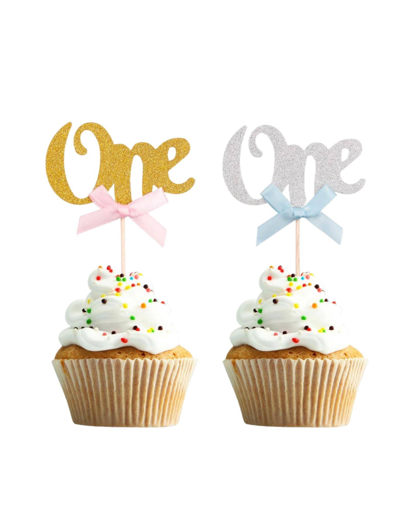 Two decorated treats topped with swirls of white frosting, each featuring a sparkly "One" pick in gold and silver.