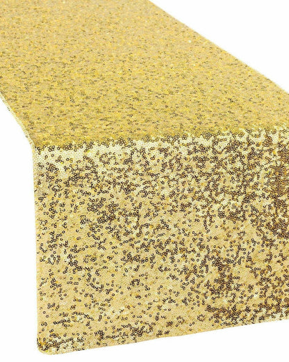 Shimmering gold sequin table runner with a sparkling surface, perfect for adding elegance to any setting.