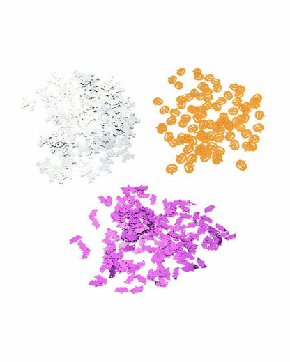 Colorful Halloween confetti featuring white ghosts, orange pumpkins, and purple bats arranged in separate piles.