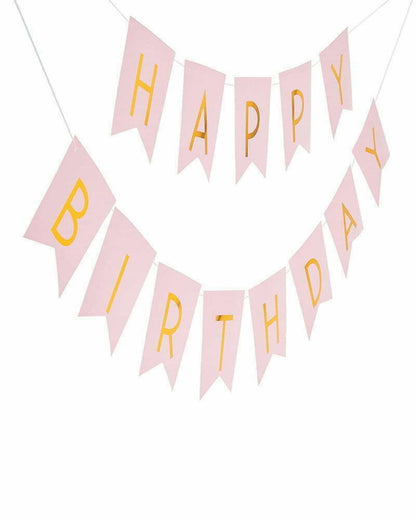 Light pink banner with gold lettering spelling "Happy Birthday" in a festive arrangement.