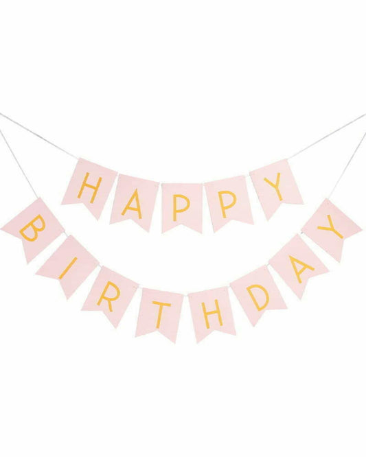 Light pink banner with golden letters spelling "HAPPY BIRTHDAY," hanging on a string.