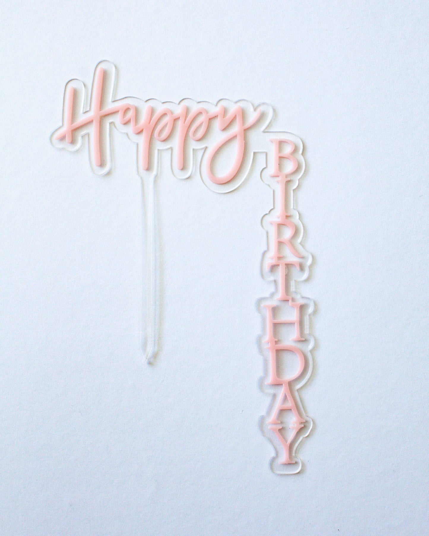 Pastel pink "Happy Birthday" topper with a playful font, perfect for celebrations and special occasions.