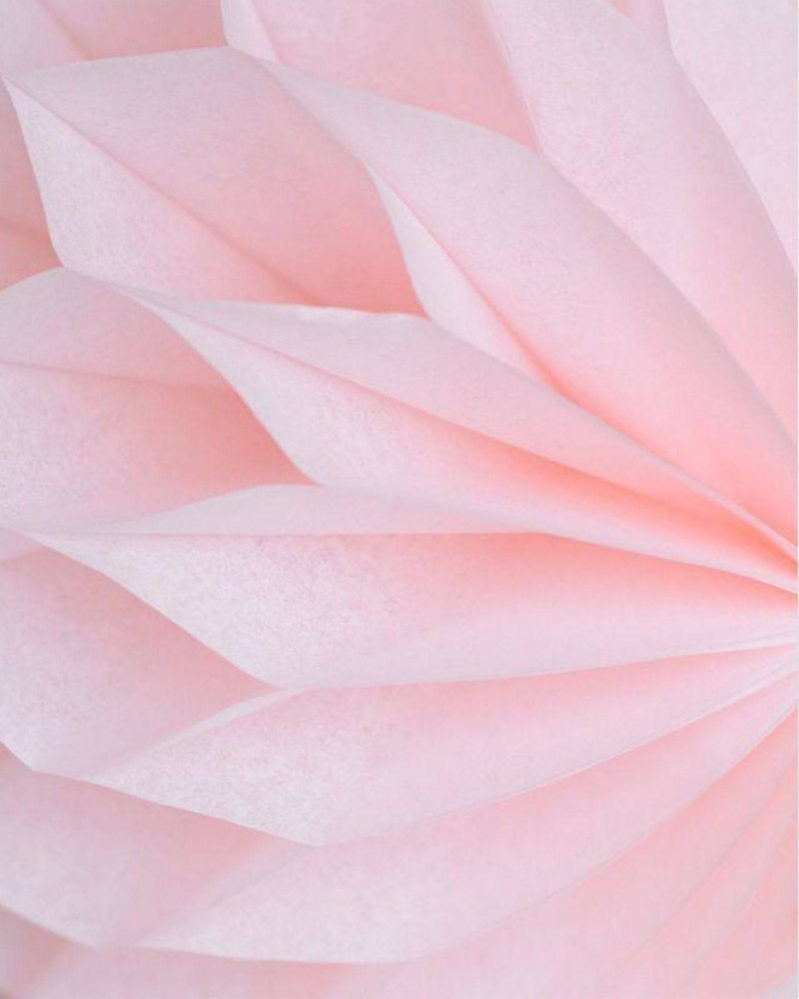 Delicate pink paper layers arranged in a honeycomb pattern, creating a soft, textured appearance.