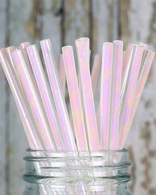 A jar filled with iridescent straws, reflecting pastel colors against a rustic wooden background.