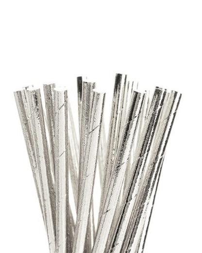 Metallic silver foil straws arranged upright, glistening with a shiny finish against a bright white background.