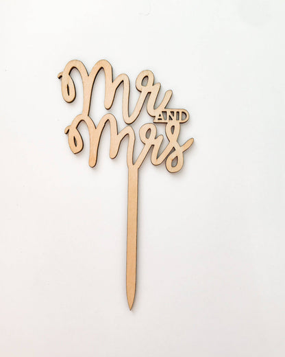 Wooden topper featuring elegant cursive text "Mr and Mrs" with a pointed base for easy insertion.