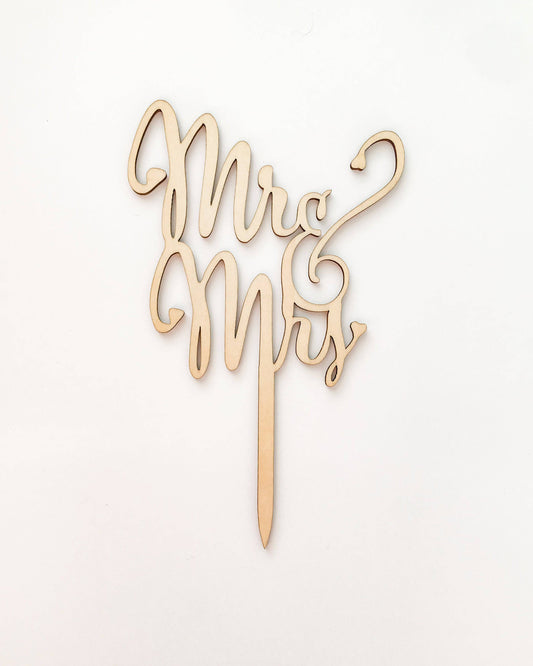 Elegant wooden topper featuring intertwined "Mr" and "Mrs" in a cursive style on a light background.