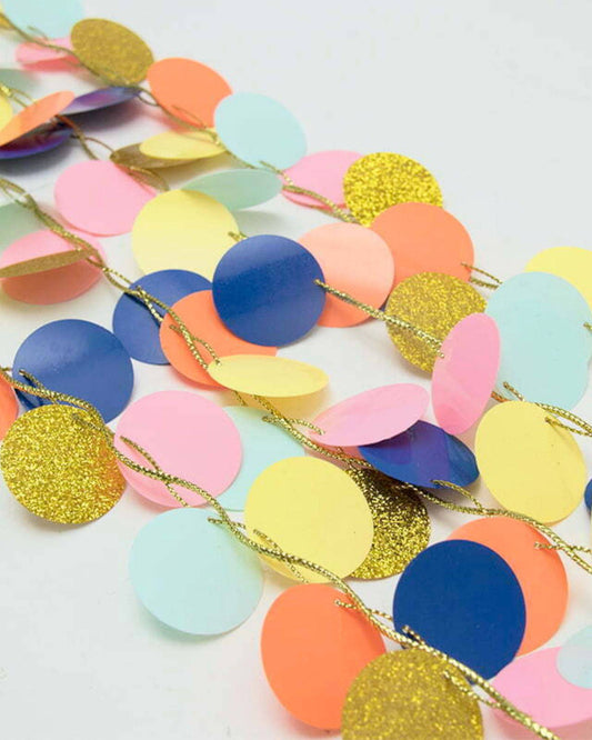 Colorful circular garland featuring a mix of matte and glittery discs in shades of pink, blue, yellow, and green.