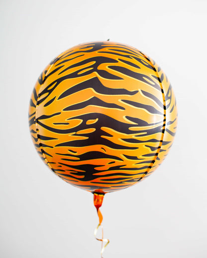 A vibrant orange and black striped balloon floats against a light background, tied with a shiny ribbon.