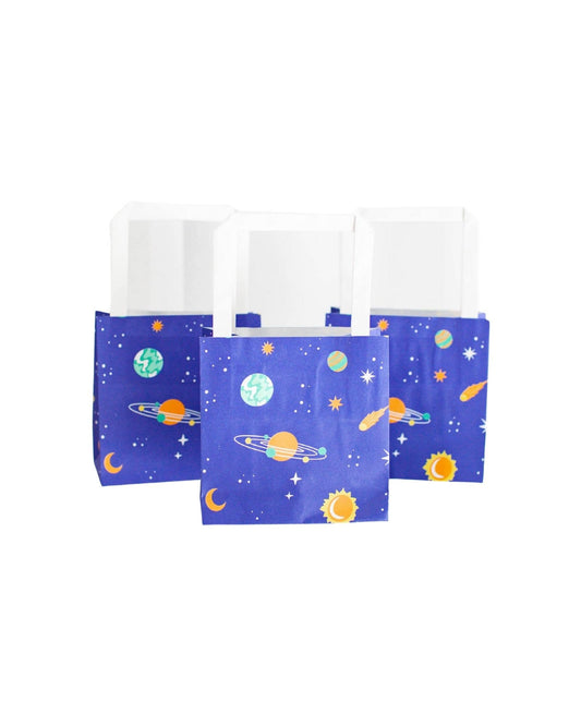 Colorful bags featuring planets, stars, and moons on a deep blue background, with white handles for easy carrying.