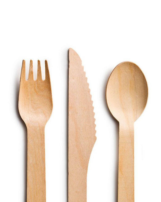 Set of three wooden utensils: a fork, knife with a serrated edge, and a rounded spoon, showcasing a natural finish.